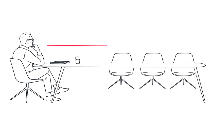Senior executive facing three empty chairs across a boardroom table.